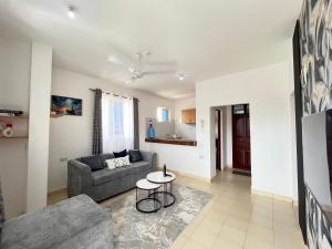 a living room with a couch and a table at Azure Stays in Mombasa