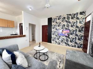 a living room with a couch and a table at Azure Stays in Mombasa +2 photos