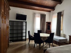 a room with a table and chairs and a bed at B&B Maria appartamento con stanza matrimoniale e soggiorno vicino alla fiera 2 in Rimini