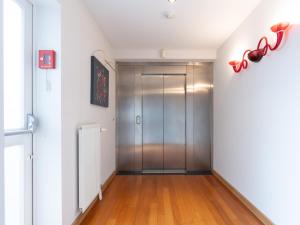 a hallway with a elevator in a building at Gîte du Vieux Moulin in Rochefort