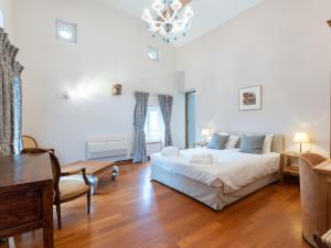 a bedroom with a bed and a table and a desk at Gîte du Vieux Moulin in Rochefort
