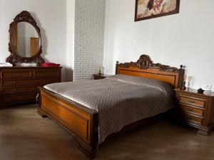 a bedroom with a bed with a mirror and a dresser at B&B Maria appartamento con stanza matrimoniale e soggiorno vicino alla fiera 2 in Rimini