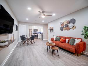 a living room with a red couch and a table at The Battery Hideaway in Marietta
