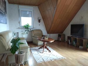 a living room with a table and a tv at Urlaub nähe Badesee und Strand - kostenlose Fahrräder in Berumbur