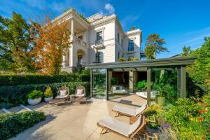 a mansion with chairs and a gazebo at Hotel Petit Bois - Adults from 14 in Balatonfüred