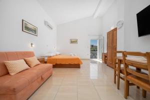 a living room with a couch and a bed at Villa Juric 1 in Baška Voda