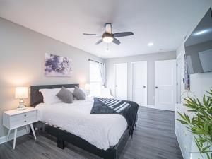 a bedroom with a bed and a ceiling fan at The Franklin in Marietta in Marietta
