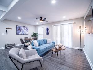 a living room with a blue couch and chairs at The Franklin in Marietta in Marietta