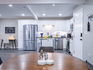 a kitchen with a table and a refrigerator at The Franklin in Marietta in Marietta +8 photos