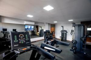 a gym with two treadmills and two machines in it at Copas Verdes Hotel in Cascavel