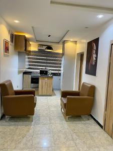 a waiting room with couches and a kitchen at Bellconpet Apartment in Sagisa