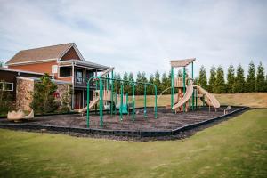 a playground in front of a house at BEAUTIFUL Jasper Highlands Cabin - AZALEA in Jasper