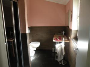 a bathroom with a toilet and a sink at Relais b& Le Rondinelle in Rosignano Solvay +49 photos