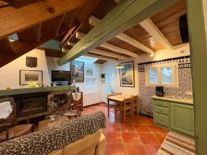a large room with a kitchen and a table at Appartement 4 personnes - Laruns in Laruns