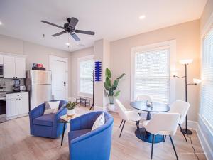 a living room with blue chairs and a table at The Maison at Marietta Square in Marietta