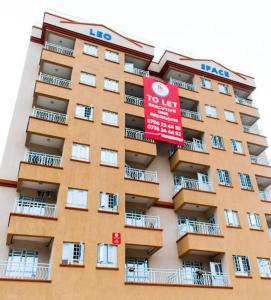 a large apartment building with a red sign on it at Beytumn Executive Apartment in Ruiru