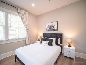 a bedroom with a large bed and two night stands at The Maison at Marietta Square in Marietta