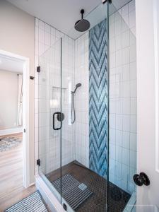 a bathroom with a shower with a glass door at The Maison at Marietta Square in Marietta