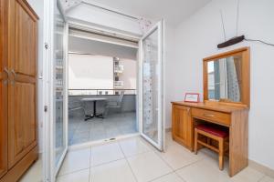 a glass door leading into a room with a desk at Villa Juric 1 in Baška Voda +76 photos