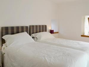 a bedroom with two beds with white sheets and pillows at Shedend in Kingston