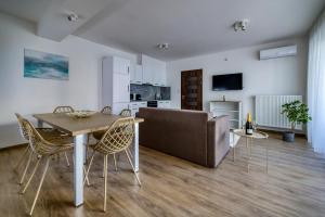 a living room with a table and a couch at Villa Oliver 2 Budapest in Budapest
