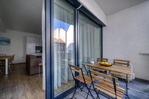 a room with a table and chairs and a large window at Villa Oliver 2 Budapest in Budapest +29 photos