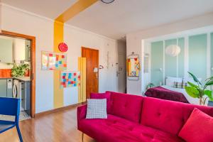 a living room with a red couch and a bed at Strasbourg Evasion Pop in Strasbourg