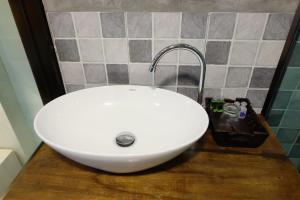 a white sink on a wooden counter in a bathroom at A Plus Deluxe Hotel in Ko Lipe