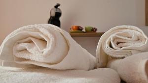 a pile of white towels on a bed at Maré Varna in Varna City