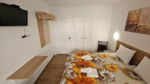 a small bedroom with a bed with flowers on it at Maré Varna in Varna City +48 photos