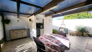 a room with a table and a kitchen with a view at La Picholine in Sorède