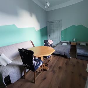 a living room with a table and a couch at Hostel Staromiejski in Grudziądz +43 photos