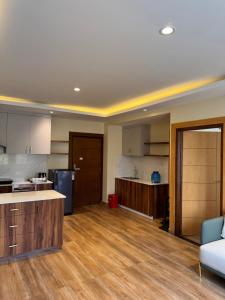 an open kitchen and living room with wood flooring at Tashi Tagay Hotel & Apartment in Kathmandu