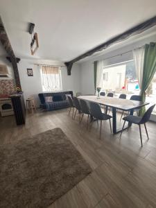 a living room with a table and chairs and a couch at Eva House in Ciocăneşti