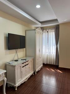 a living room with a tv and a entertainment center at Tashi Tagay Hotel & Apartment in Kathmandu