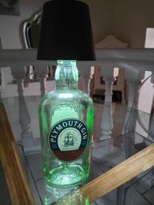a green bottle on a glass table with a lamp at Domus Antiqua San Lorenzo in Genoa +52 photos