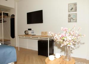 a living room with a table and a vase of flowers at Linza Suite in Babaeski