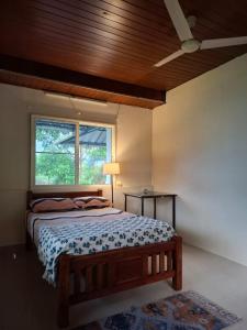 a bedroom with a bed and a window at The Beach House in Cochin