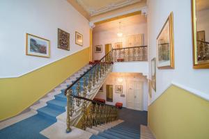 a spiral staircase in a building with paintings on the walls at Hotel Luisa in Františkovy Lázně