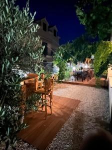a patio with a table and chairs at night at BCM Weidinger in Mirce