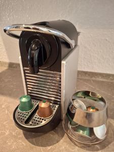 a toaster is sitting on a counter with some cups at City-Appartement Pirna in Pirna