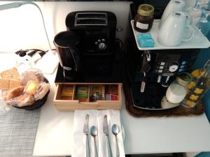 a table with utensils on a table with a counter top at Bed and Breakfast VILLA ARANCIO Ghiffa in Ghiffa