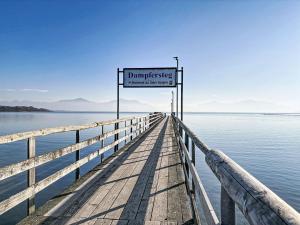 a sign on a pier in the water at Apartment Alpenseeblick by Interhome in Seebruck +23 photos
