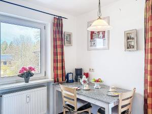 a kitchen with a table and chairs and a window at Apartment Alpenseeblick by Interhome in Seebruck