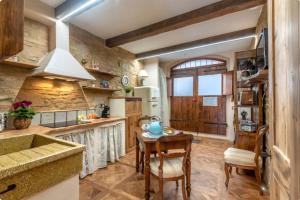 a kitchen with a table and a dining room at Il Girasole -with Garden- in Buonconvento