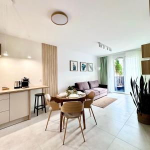 a kitchen and living room with a table and chairs at Apartment Chrzanòw in Chrzanów