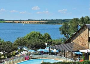 a swimming pool with a view of a lake at ZEcamping 4 étoiles chiens acceptés tennis piscine chauffée in Salles-Curan