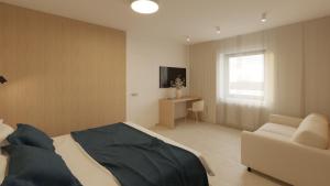 a bedroom with a bed and a couch and a television at TWILL Apartments in Brno