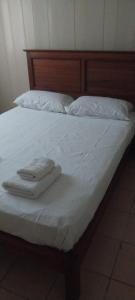 a bed with white towels on top of it at apartamentos Don Oscar in Federación
