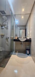 a bathroom with a sink and a shower at Sunflower Hotel Syariah near Juanda Airport in Dares +46 photos